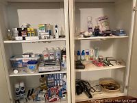 Overview of shelves showing various personal care and health products including Braun toothbrush, bandages, mouthwash, creams, and dental items.