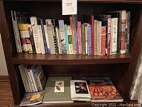 Shelf of assorted books covering logic, collectible glass, birds, nature, and fiction including Ulysses with Cliff Notes.