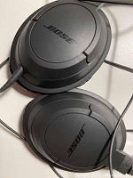 Close-up of the black Bose SoundTrue around-ear headphones showing ear cups with Bose logo and wired connection.
