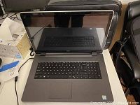 Photo of opened Dell laptop showing keyboard and display off