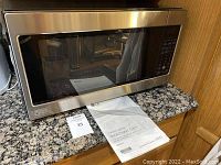 LG stainless steel microwave oven model LCRT2010 placed on kitchen counter, clean condition.