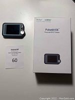 EKG tracker device next to its original box with brand and model name visible.