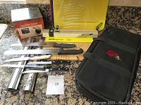 Photo showing knives, cutting boards, edge guard, carrying case and electric sharpener.