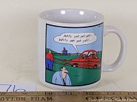 Front view of the coffee mug showing the Far Side comic strip illustration with characters and dialogue.
