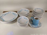 Full set of 35 pieces grouped by plate size, bowls, and pitcher with underplate.