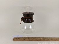 Image of Comfify Chemex style coffee maker clear glass carafe with brown wooden collar and leather tie, ruler for scale