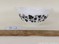 Side view of Pyrex Cinderella mixing bowl showing black Gooseberry pattern and spout.