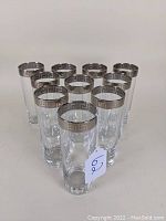 Overhead group shot of 10 Greek Key highball tumblers arranged in cluster to show pattern and quantity.