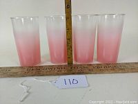 Four tumblers arranged in a row with a tape measure showing height about 5 inches.