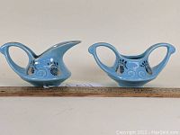 Front and side view of creamer and sugar bowl set placed next to a ruler for scale.