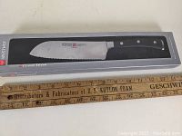 Knife in original packaging showing full blade and handle.
