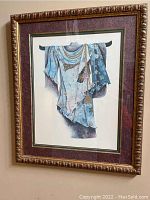 Large ornate framed artwork of a blue Japanese robe hanging on a wooden rod, displayed in detail showing the robe's floral patterns and gold accents, framed in an ornate maroon and_gold frame.