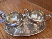 Overall view of creamer and sugar bowl on tray