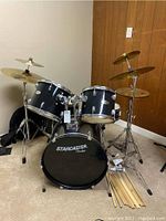 Front view of black Starcaster by Fender 5-piece drum kit with cymbals