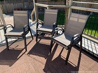 Three of the patio chairs arranged on a deck showing design and condition.