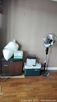 Photo showing Kenmore humidifier, replacement wicks, two Coleman coolers, and Noma oscillating stand fan.