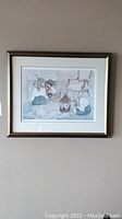 Framed print artwork of children playing with a gold frame and double matte, in good visible condition, wall-hung