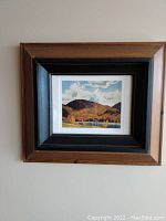 Full view of the framed print showing landscape with a wooden frame and double matting.