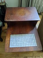 Top and lower tiled shelf view of Midcentury Modern wooden end table showing wood grain and tiled inset.