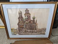 Full view of the watercolor print depicting the Church of the Savior on Spilled Blood in Russia. The frame is gold-tone and the artwork is matted.