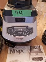 Close-up of blender base control panel showing brand, power button, speed settings (1, 2, 3), single serve mode, and pulse button