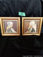 Both framed prints of young girls in Dutch costume, shown side by side