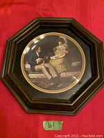 Front view of the framed collector plate showing the artwork 'Pondering the Porch' by Norman Rockwell in a dark oak octagonal frame.