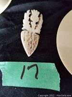 Photo showing the front of the carved ivory brooch with leaf and textured design