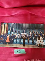 Full color postcard showing the Lawrence Welk Orchestra on stage with Lawrence Welk center front.