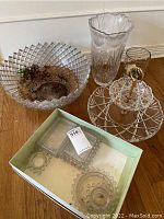 Overview photo of punch bowl with soil, tall etched vase, two-tier tray with gold handle, and small serving dishes in box.