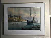 Front view of framed print showing maritime scene with a ship and fort on the shore.