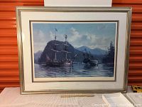 Framed limited edition print showing maritime scene with ships and mountains