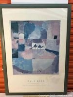 Full view of framed Paul Klee poster showing the artwork and green wooden frame with minor wear marks.