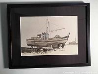 Full frontal image of the framed watercolor showing the boat resting on land with details of the mast and cabin. Image captures size and framing.