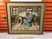 Full view of the framed painting showing the cobbler in his workshop with wooden floor and stone walls.