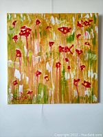 Front view of square canvas painting showing abstract floral motif on golden background and artist signature