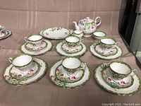 Overall spread of the tea service showing all pieces arranged on a table.