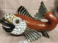 Front left angle view showcasing head, eye detail with gold accents, and right side fin