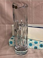 Vase standing upright showing hand cut facets and scalloped top edge