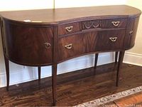 Angled front left view showing curved profile, drawers and cabinets