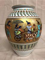 Front view showing Egyptian procession motif on gold band