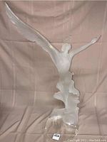 Front view of entire acrylic sculpture showing frosted dancer figure with wings and clear flowing base