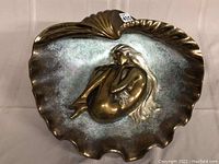 Top-down view of shell-shaped sculpture with curled figure