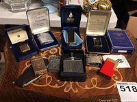 Overall view of ten lighters arranged in two rows on decorative surface