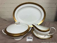 Overview of platter, covered bowl, gravy boat and underplate on table