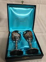 Pair of silver plated Burke & Wallace wine goblets in fitted presentation case with turquoise satin lining.