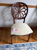Front and side view of antique wooden chair with spider web backrest and light upholstered sailboat seat showing condition and design