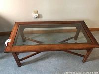 Top view showing wood frame with beveled glass inset and cross-bracing underneath.