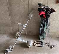 Golf cart with golf bag filled with clubs and Nike cleats on floor