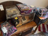 Overview of multiple boxed Playmates Star Trek figure sets and sealed blister cards displayed on a bench